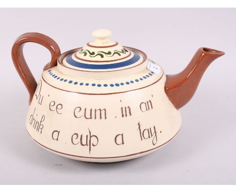 A Torquay Ware teapot, inscribed "Du ee cum in an drink a cu a tay", 14" wide (small chips to spout)Condition:Chip to spout, 