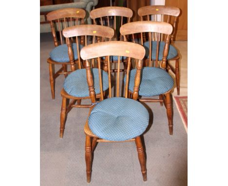 A set of six Windsor spindle back chairs with panel seats, on turned and stretchered supports