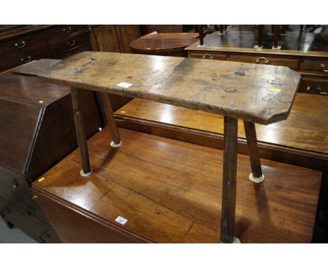 A late 19th century oak "pig" bench, on splay supports, 31 1/2" wide x 17" high