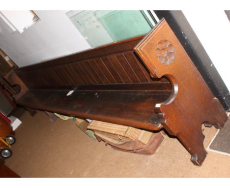 A carved oak pew with Gothic panel ends, 156" long