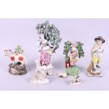 A late 18th century figure "Winter", 7" high, a similar figure with flowers, three sheep groups