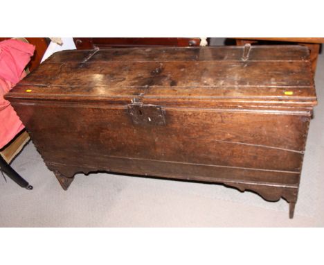 A late 17th century oak boarded coffer with chip carved details, on panel end supports with original wrought iron strap hinge