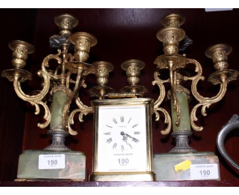 A pair of gilt metal and onyx five-branch candelabra and a Jonelle brass cased carriage clock