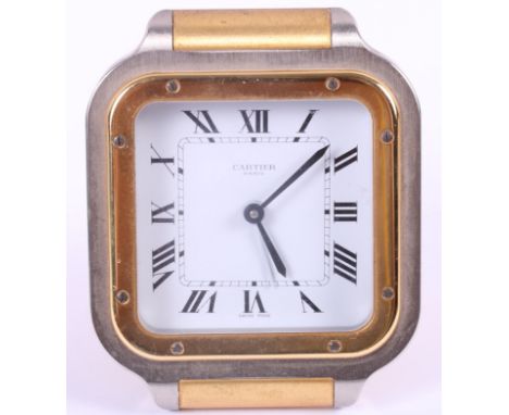A Cartier steel and gilt cased travelling alarm clock, white enamel dial with Roman numerals and quartz movement