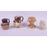A Doulton and Watts stoneware Napoleon jug, a stoneware tobacco jar, in the form of a Turk, a