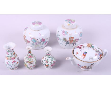 Two Chinese porcelain famille rose decorated ginger jars and covers, three famille vert miniature vases and a similar feeding