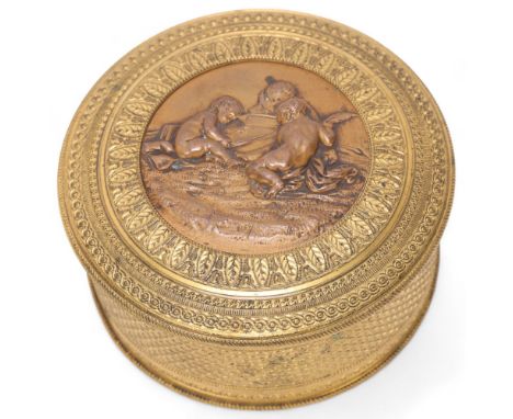 A French 19th century circular gilt-bronze box, with relief decorated lid and mirror inside, diameter 10cm 