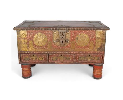 A large 18th century hardwood Zanzibar chest, with bronze carrying handles, applied pierced and engraved brass panels and stu