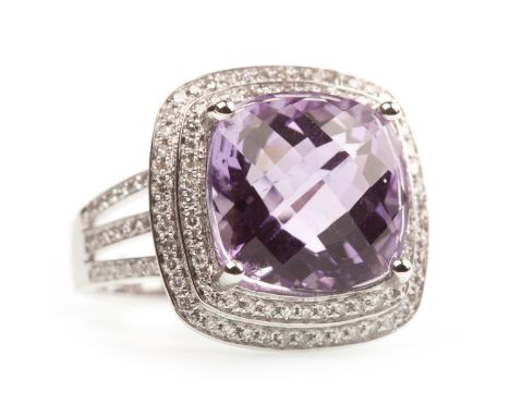 AMETHYST AND DIAMOND RING, the cushion shaped amethyst of approximately 8.37 carats, within a double diamond halo, on trifurc