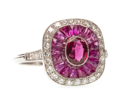 RUBY AND DIAMOND RING, the oval ruby surrounded by calibre cut rubies bordered by round brilliant cut diamonds, the diamonds 