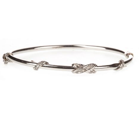 GEM SET BANGLE, of oval form, with overlaid gem set sections, 63mm inner diameter, unmarked, 5.2g
