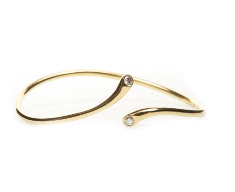 DIAMOND SET TWIST BANGLE, each terminal set with a round brilliant cut diamond of approximately 0.07 carats, in eighteen cara