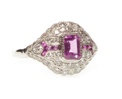 PINK SAPPHIRE, RUBY AND DIAMOND RING, the central step cut pink sapphire with ruby accents to each shoulder, to a diamond set