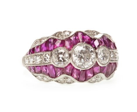 RUBY AND DIAMOND RING, with three collet set round brilliant cut diamonds flanked by four smaller diamonds, bordered by calib