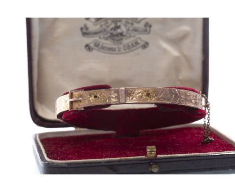 VICTORIAN BANGLE, with belt buckle motif and foliate engraving to the front section, 60mm inner diameter, in nine carat gold,