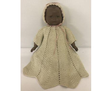 A reproduction ceramic head and hands black baby doll. With soft body and legs.