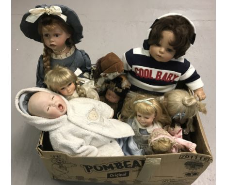 A box of modern vinyl and ceramic collectors dolls. To include Drowsy Baby by Rupert, The Dolls Artwork Inc.