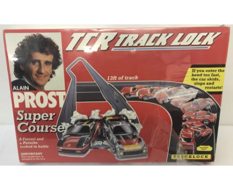 A new, boxed and sealed 1990, Buckingham Toys, TCR Track Lock; Alain Prost Super Course #3611-3. Box contains: 13ft of track,