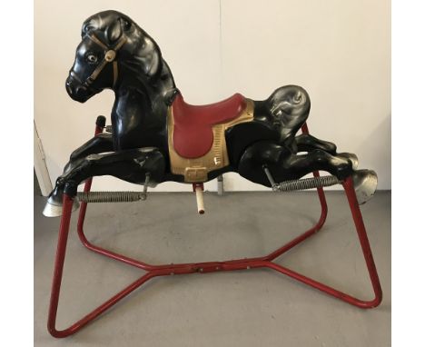 A vintage metal Mobo rocking horse in black with red saddle and frame. Springs in good order and paintwork in very good origi