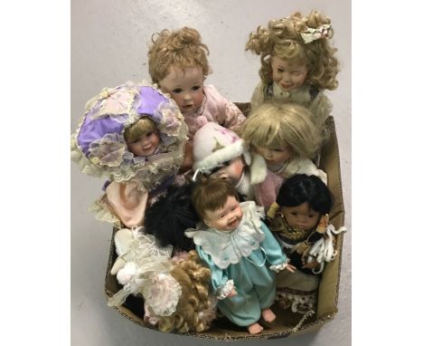 A box of modern ceramic collectors dolls. To include Native American style dolls and Kathy Heppensteel.