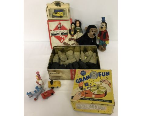 A box of mixed vintage toys. To include carved chess pieces, Napro Gram fun record player, McDonalds toys and world dolls.