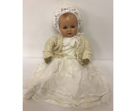 A large soft body vintage doll with Armand Marseille composition head. Painted face with open mouth and top to teeth.