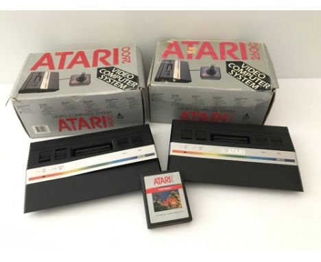 2 boxed 1980's Atari 2600 junior video games consoles with an original "Centipede" game cartridge. Together with an AC power 