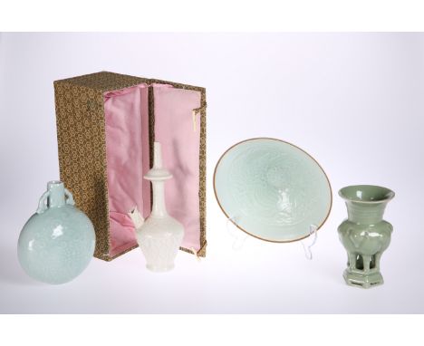 FOUR PIECES OF CHINESE CELADON WARE, comprising: an eggshell bowl, moulded to the well with a dragon; a lotus leaf moulded fl