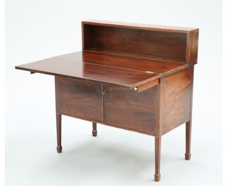 A GEORGIAN MAHOGANY DESK CABINET, with shelf back above a foldover top over a pair of banded cupboard doors, raised on square