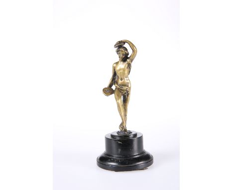 AFTER THE ANTIQUE, A DESK BRONZE OF A FEMALE NUDE WITH CYMBALS, mounted on a wooden plinth. Height overall 15.25cm