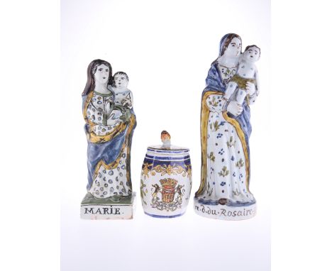 TWO 19th CENTURY QUIMPER POTTERY FIGURES OF THE VIRGIN, each modelled holding the Christ Child, the larger inscribed to the b