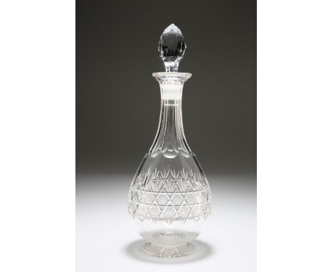 A CUT-GLASS DECANTER OF FLASK FORM, EARLY 20th CENTURY, with faceted stopper over a panelled neck, the body with a central do