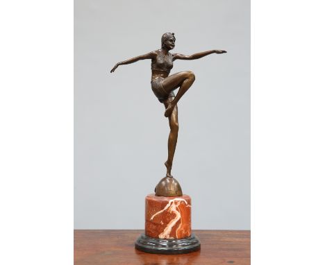 A BRONZE FIGURE OF A DANCER, IN ART DECO STYLE, posing with arms outstretched and raised right leg, she stands on a domed bas