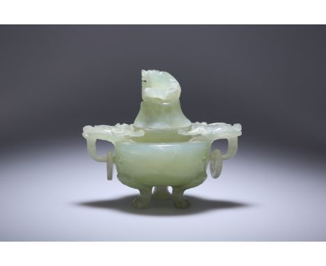 A CHINESE JADE CENSER, of characteristic shape, with zoomorphic ring handles and raised on paw feet, the domed cover with a t