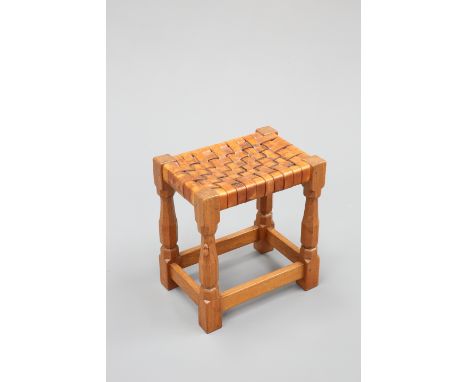 ROBERT THOMPSON OF KILBURNA MOUSEMAN OAK STOOL, CIRCA 1960, the original woven leather seat raised on faceted baluster legs t