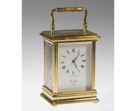A 20TH CENTURY BRASS CASED CARRIAGE CLOCK, signed St. James London, the white enamel dial with Roman numerals, the case with 