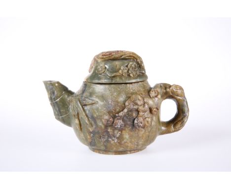 A CHINESE CARVED HARDSTONE TEAPOT, carved in relief with prunus blossom. 11cm