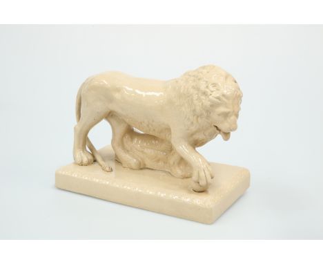 A STAFFORDSHIRE SALT-GLAZED MODEL OF A LION, 19TH CENTURY,  naturalistically modelled, standing to the left, one front paw re