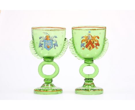 A PAIR OF BOHEMIAN ENAMEL PAINTED MARRIAGE GLASSES, in green glass, each with flattened ovoid bowl, painted with differing co