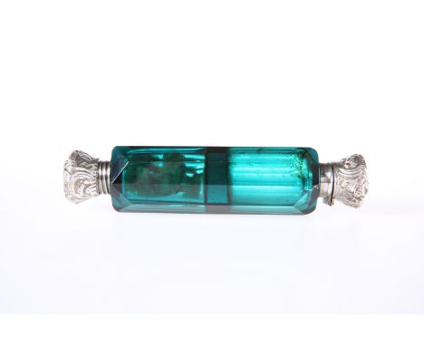 A VICTORIAN GREEN GLASS DOUBLE-ENDED SCENT FLASK, with silver tops (unmarked but tested). 12cm