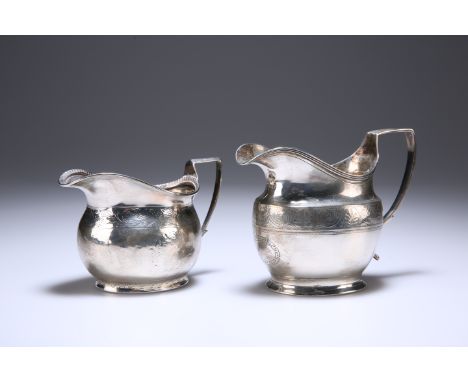 TWO GEORGIAN SILVER CREAM JUGS, the first London 1807, the second with indistinct marks, each with bright-cut engraving. Gros