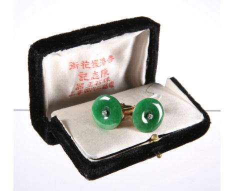 A PAIR OF CHINESE JADE AND DIAMOND CUFFLINKS, the round jade disc centred by a four-claw set diamond, mounted in gold (tests 