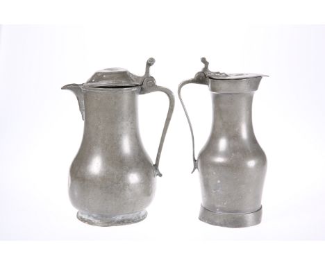 TWO PEWTER LIDDED FLAGONS, 18th CENTURY, the first French, of baluster form, with reeded scroll thumbpiece and marked for Rog