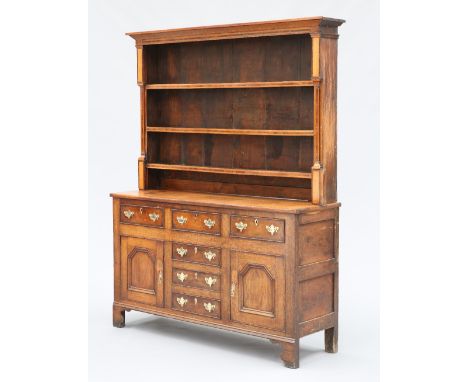 AN INLAID OAK DRESSER AND RACK, NORTH WALES, EARLY 19TH CENTURY, the boarded rack with projecting cornice above three shelves