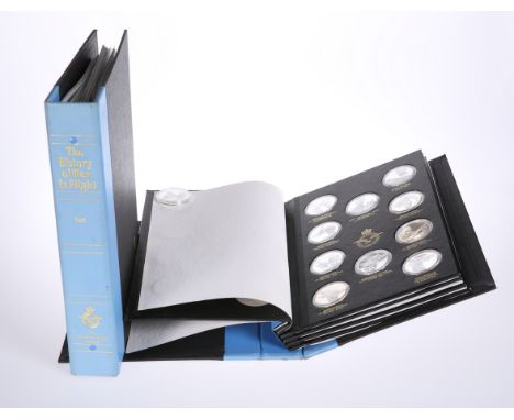 A JOHN PINCHES "THE HISTORY OF MAN IN FLIGHT" SILVER MEDALLION COLLECTION,&nbsp;comprising of two bound folders, the first co
