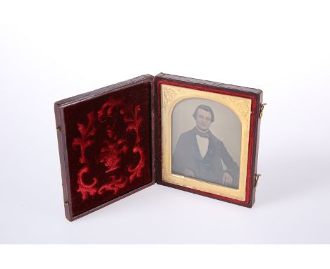 A VICTORIAN PORTRAIT DAGUERREOTYPE, of a gentleman, in a leather case with tooled velvet lining. 9.5cm by 8cm