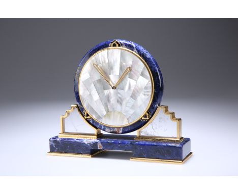 A CARTIER LAPIS LAZULI AND MOTHER-OF-PEARL SUNBURST DESK CLOCK, the circular dial composed of mother-of-pearl segments with g