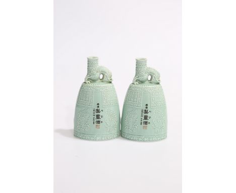 A PAIR OF CHINESE CELADON FLASK-FORM VASES, of tapering oval-section, the neck moulded as dragons. 21cm