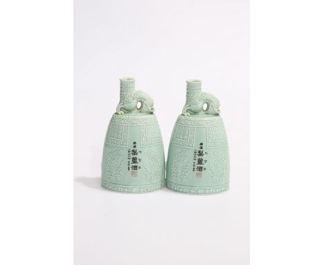 A PAIR OF CHINESE CELADON FLASK-FORM VASES, of tapering oval-section, the neck moulded as dragons. 21cm