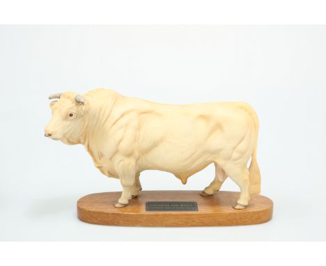 A BESWICK MODEL OF A CHAROLAIS BULL, on wooden plinth. 20cm high, plinth 29.5cm